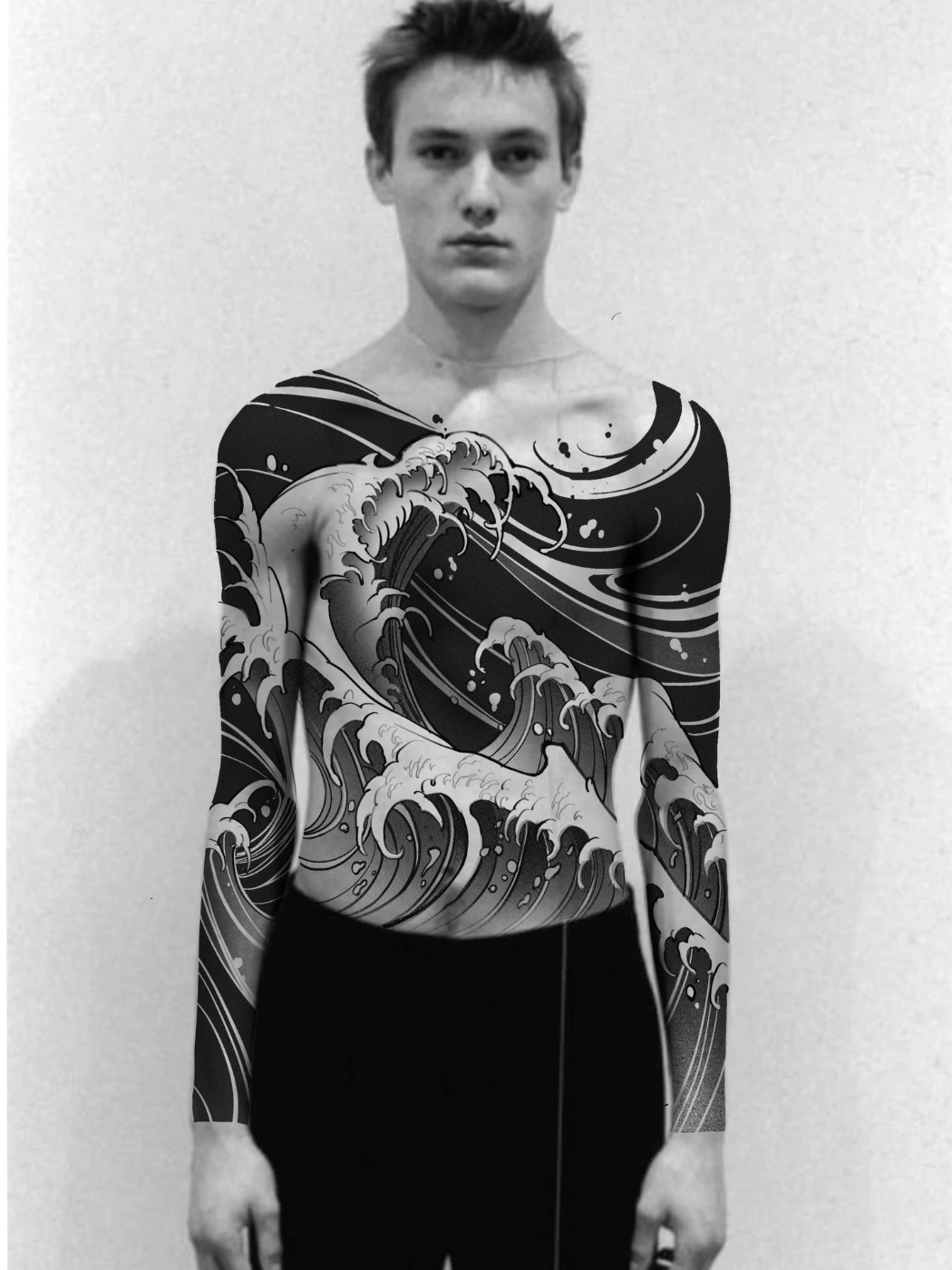 Large black-and-grey wave tattoo on full sleeve and chest.
