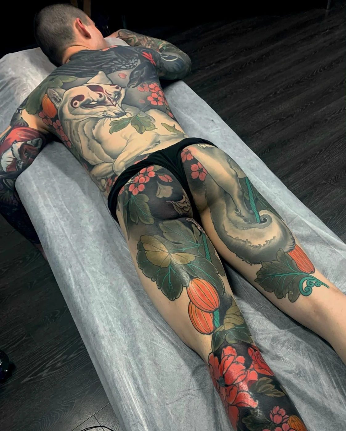 Large Japanese tattoo featuring koi fish and flowers.