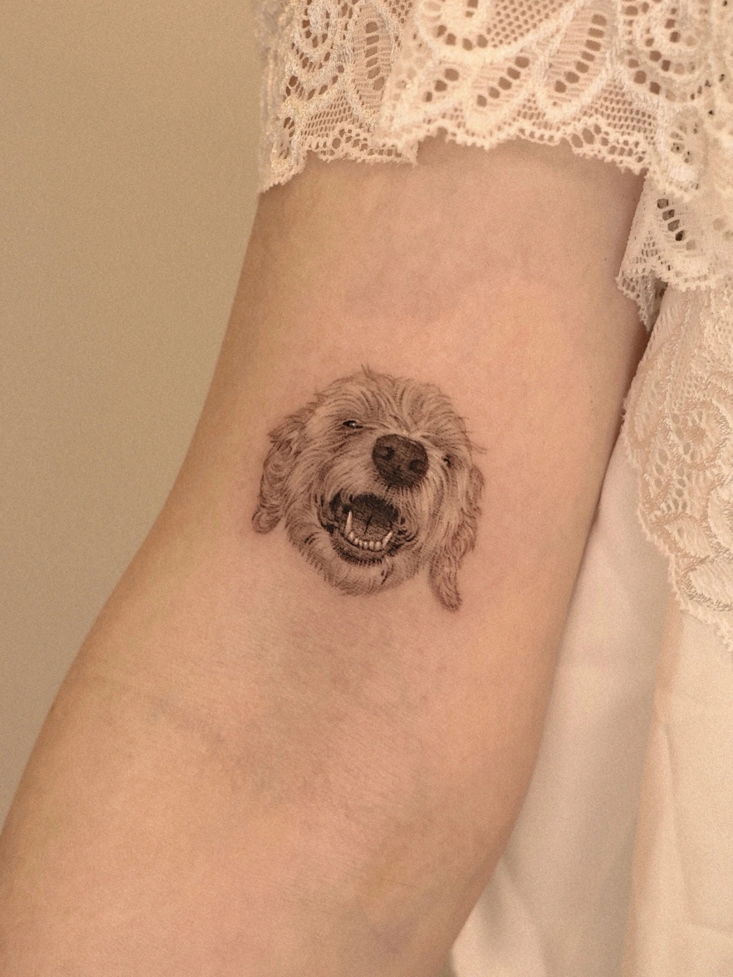Realistic dog face tattoo on the arm.