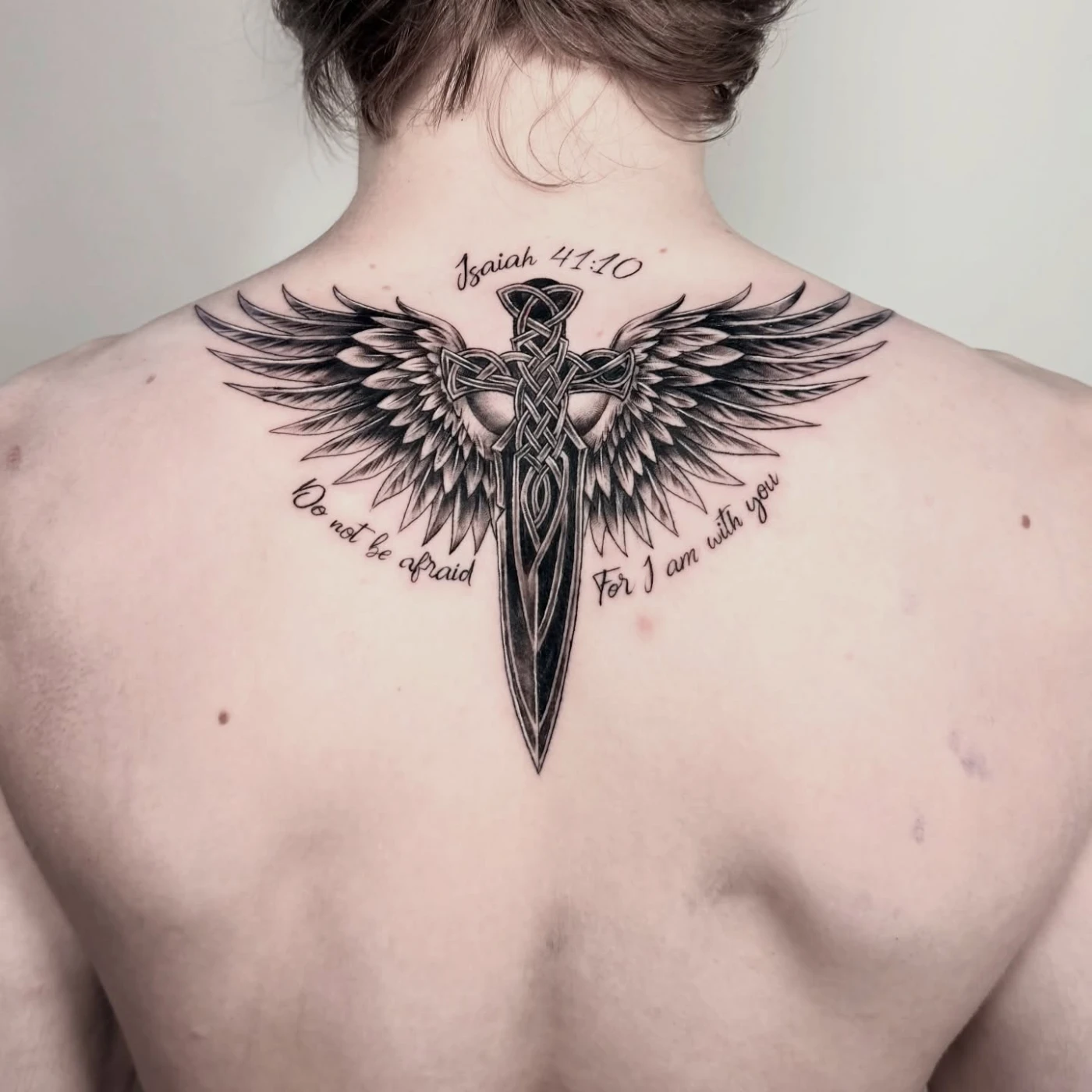 Large black-and-grey angel wings back tattoo by a Melbourne artist