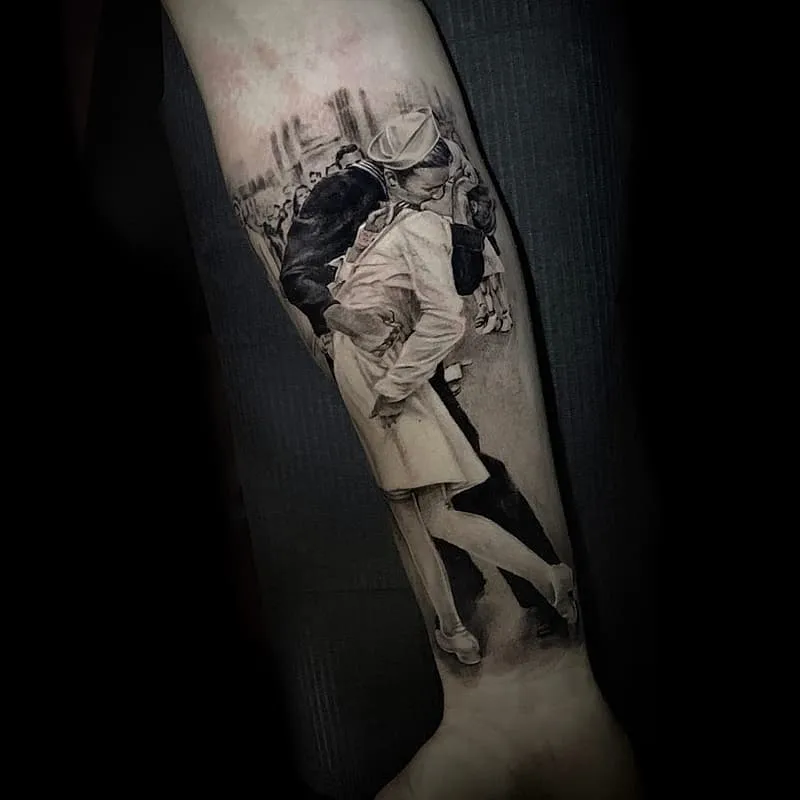 Realism tattoo of a vintage kiss on forearm.