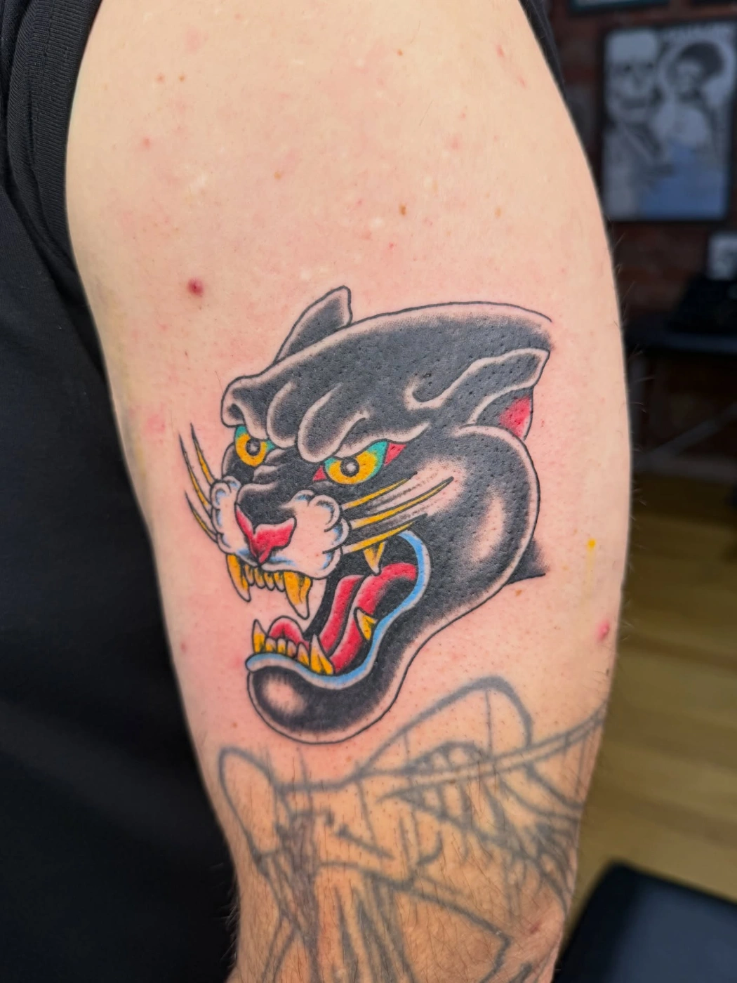 Vibrant new-school panther tattoo on arm.