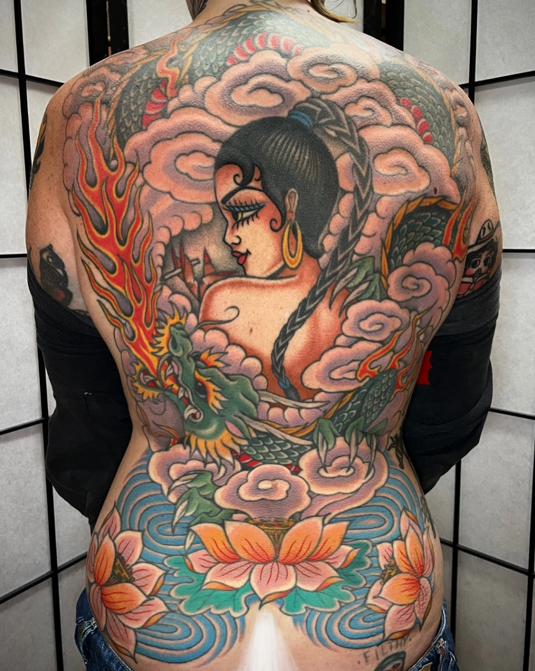 Large colorful Japanese tattoo on a woman's back.