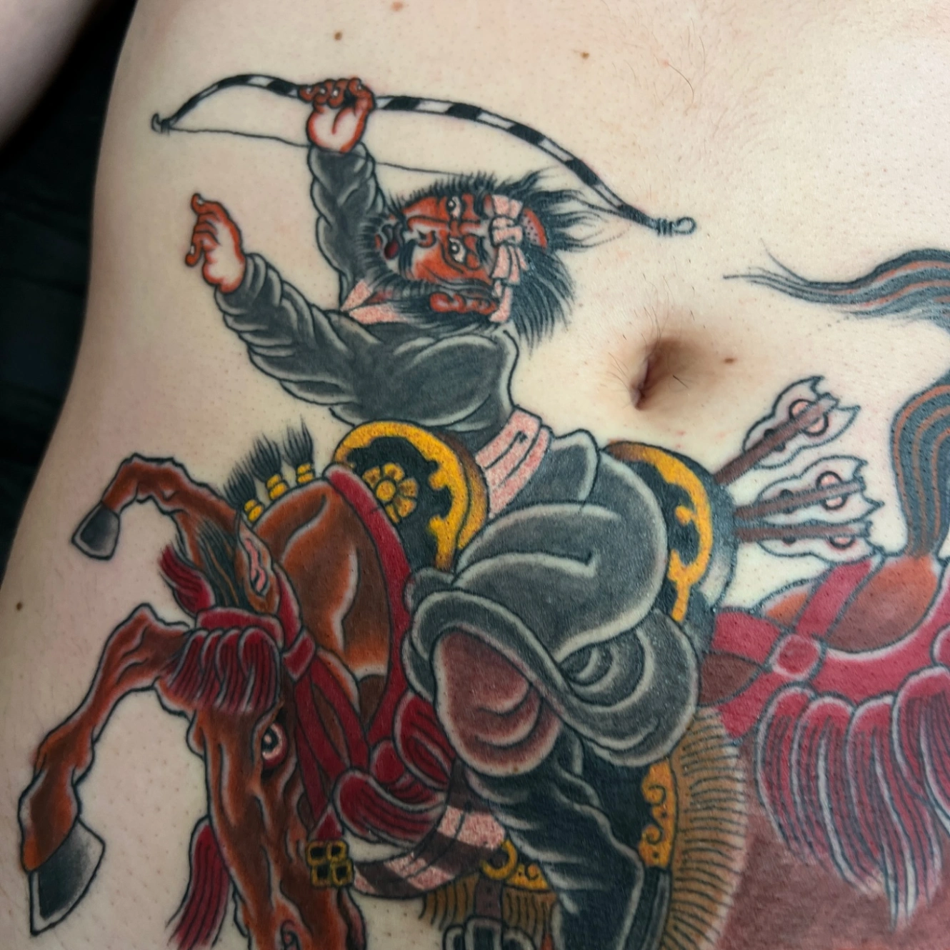 Japanese warrior tattoo on chest with horse and bow.