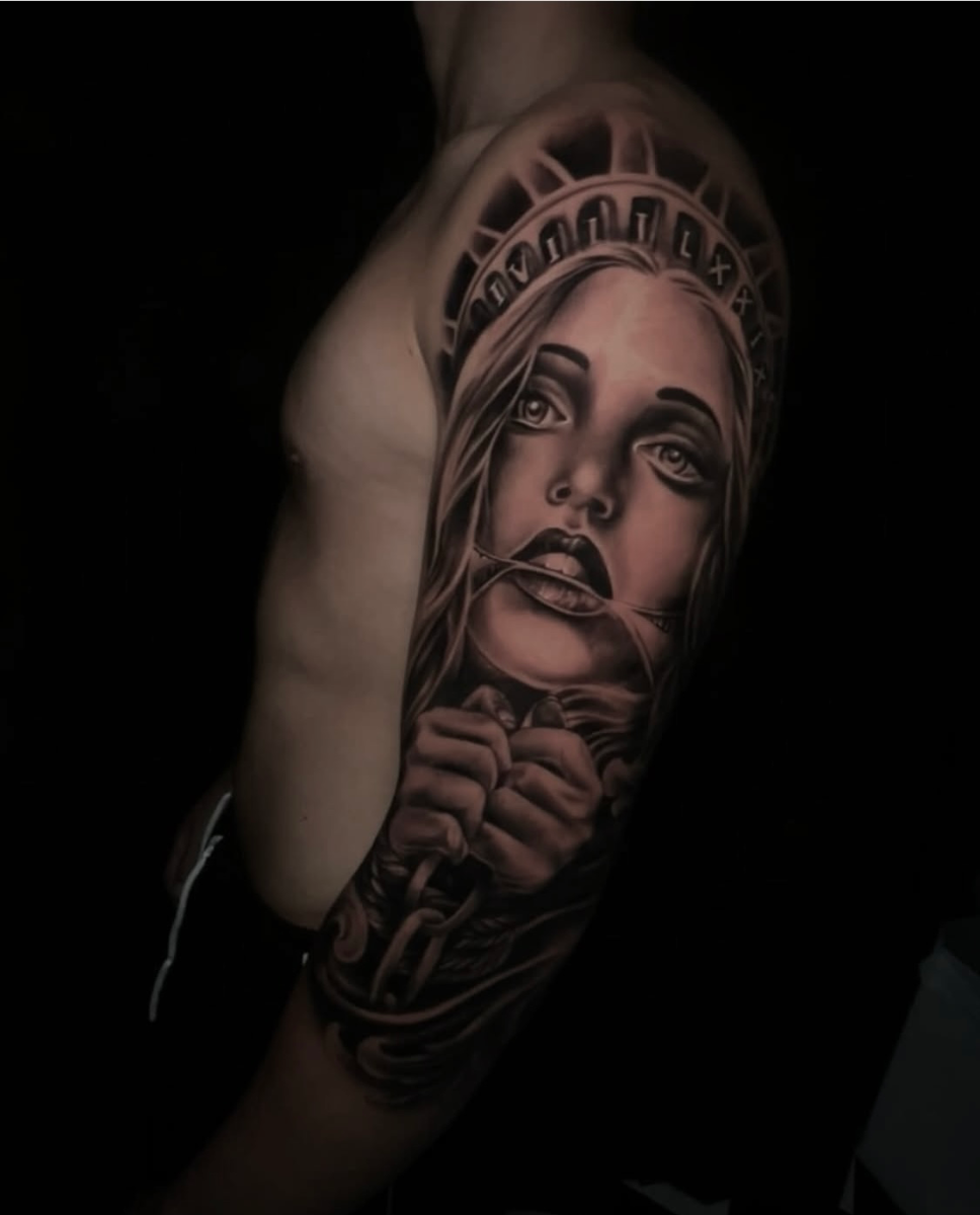 Realistic full-sleeve tattoo of a woman holding a chain.