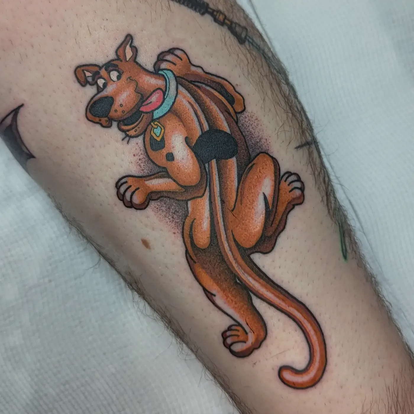 Colorful Scooby-Doo tattoo on forearm.