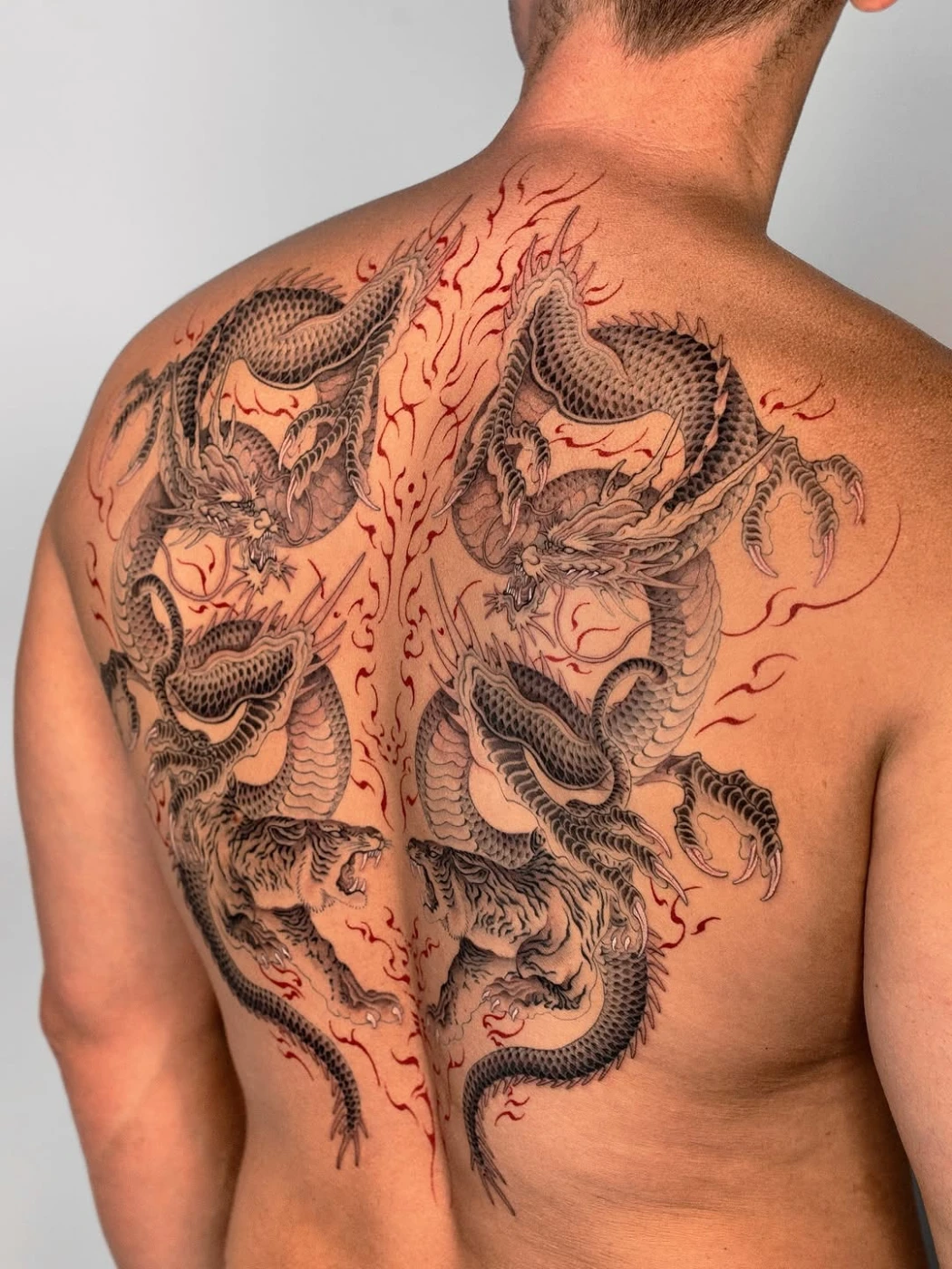 Large Japanese dragon tattoo on a man's back.