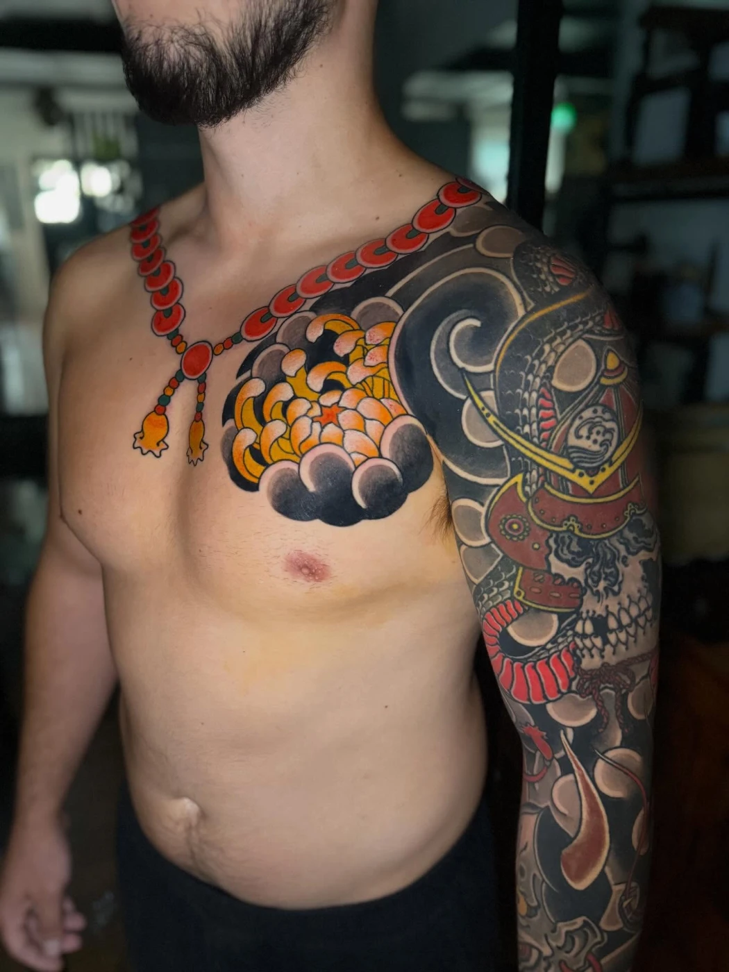 Large colorful Japanese dragon tattoo on shoulder and arm.