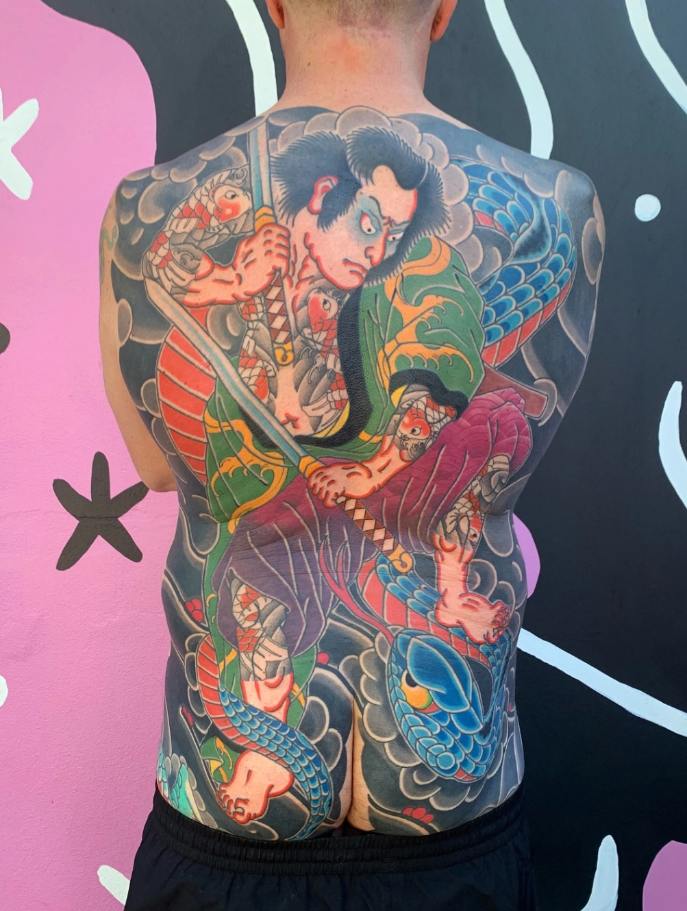 Large colorful Japanese tattoo on a man's back.