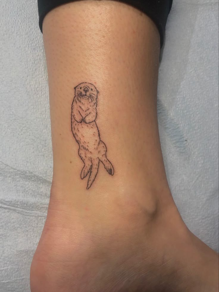 Playful Sea Otter Ankle Tattoo