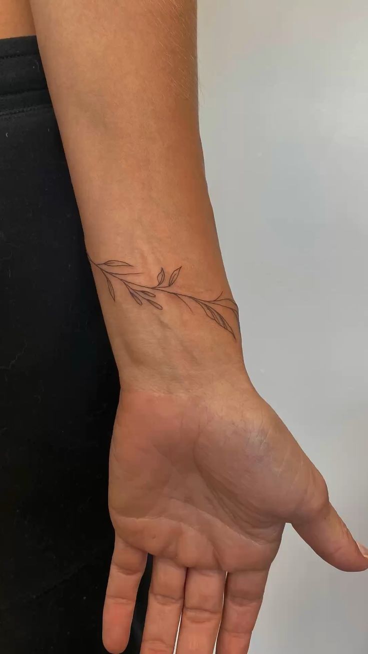 delicate vine wrap ankle tattoo