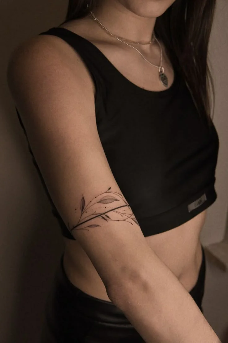 elegant minimalist floral arm tattoo