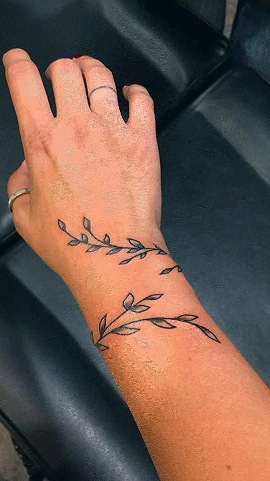 Delicate Arrow and Leaf Wrist Tattoo