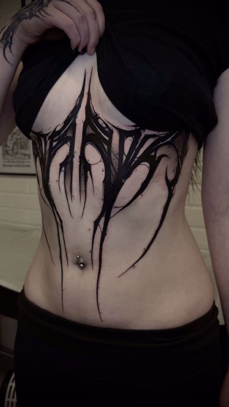 bold blackwork ribcage tattoo design
