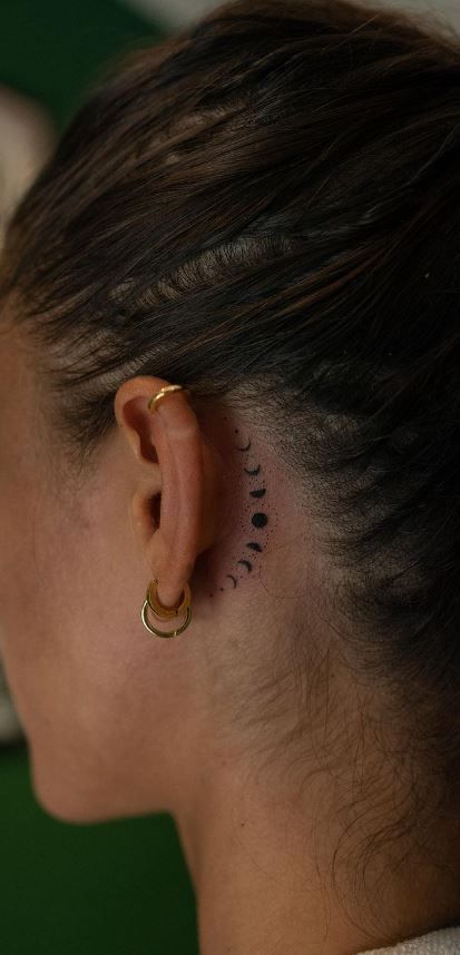 Celestial Minimalism: Behind-the-Ear Moon Phase Tattoo