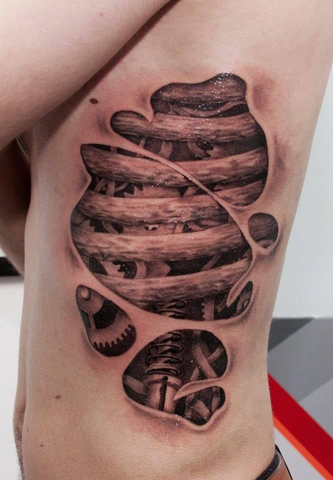 Intricate Biomechanical Ribcage Tattoo