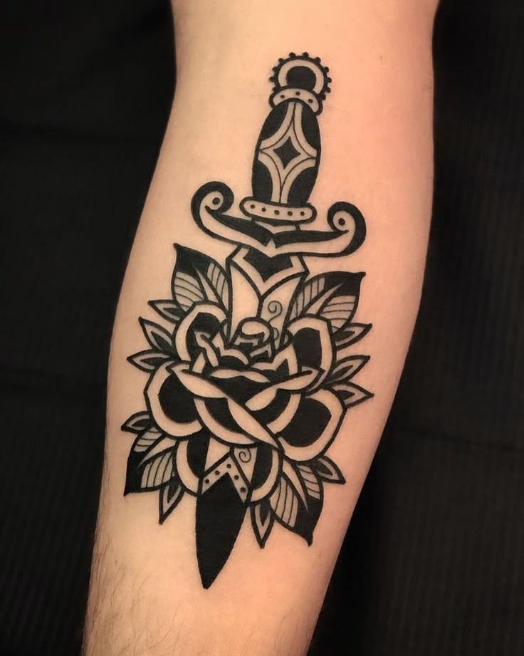 Strength and Beauty: Traditional Rose and Dagger Tattoo