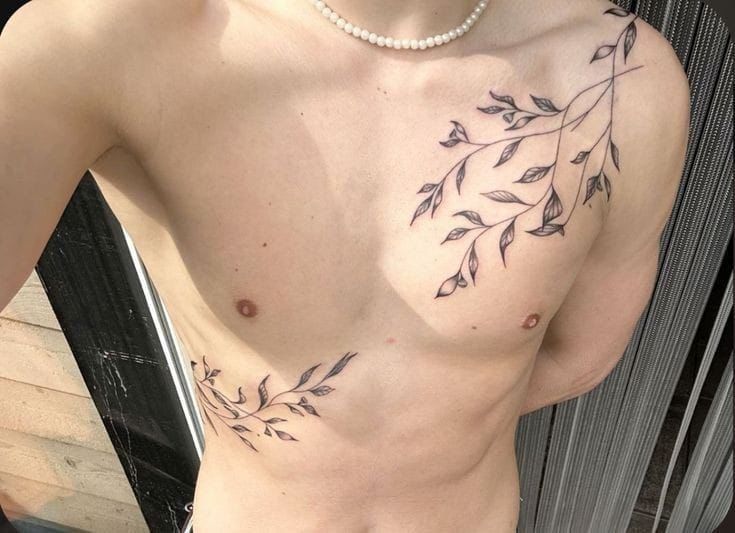 elegant minimalist chest tattoo with leaves