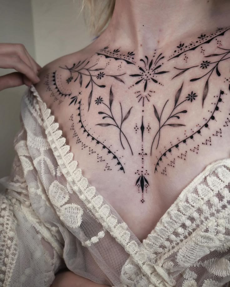 elegant blackwork chest tattoo design