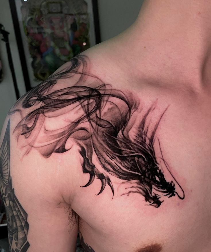 artistic blackwork dragon chest tattoo