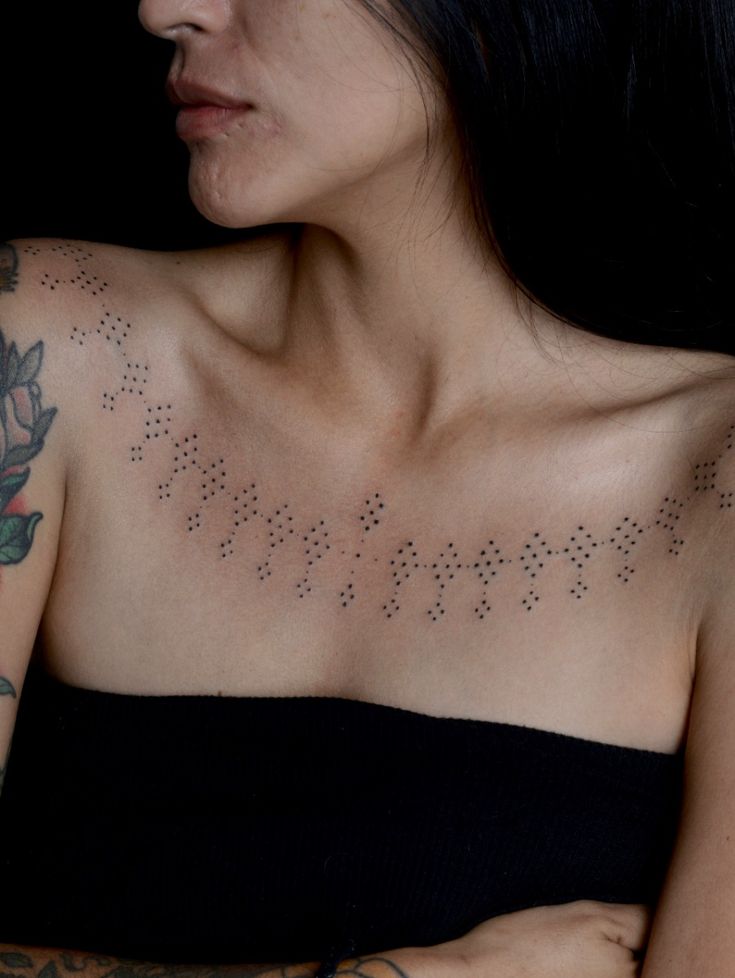 elegant dotwork shoulder tattoo