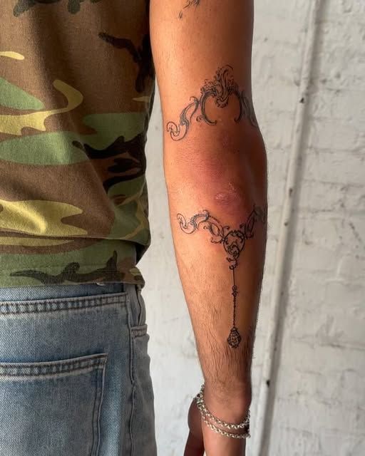 Intricate Blackwork Elbow Tattoo for Men