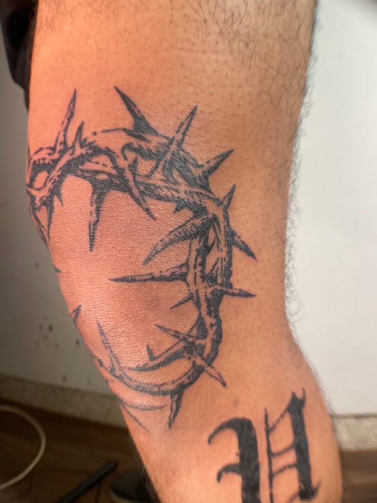 bold crown of thorns elbow tattoo