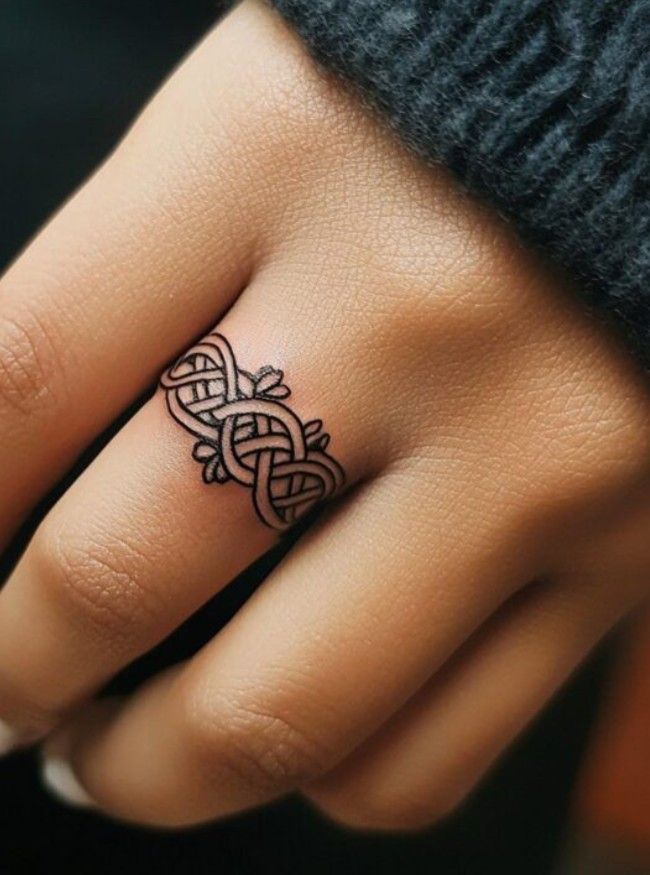 elegant blackwork finger tattoo design