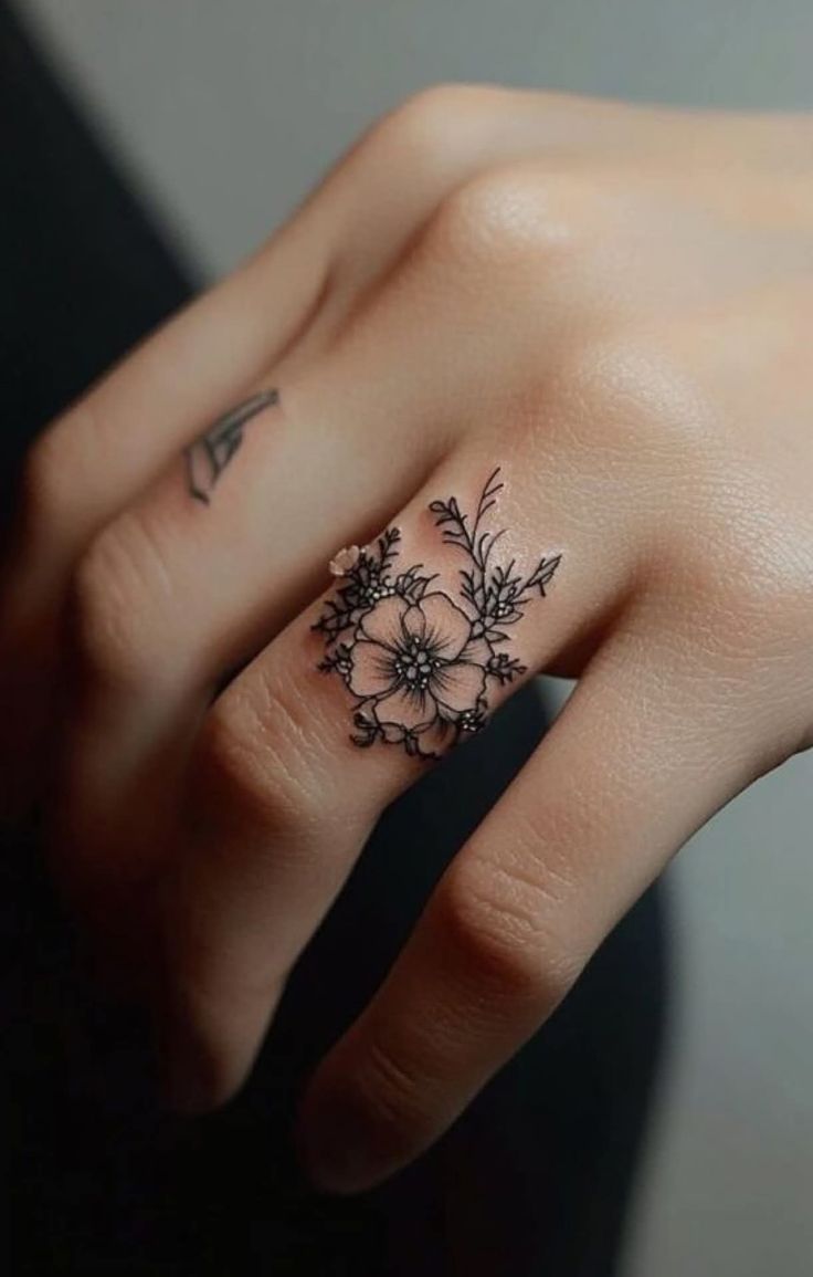 delicate floral finger tattoo design