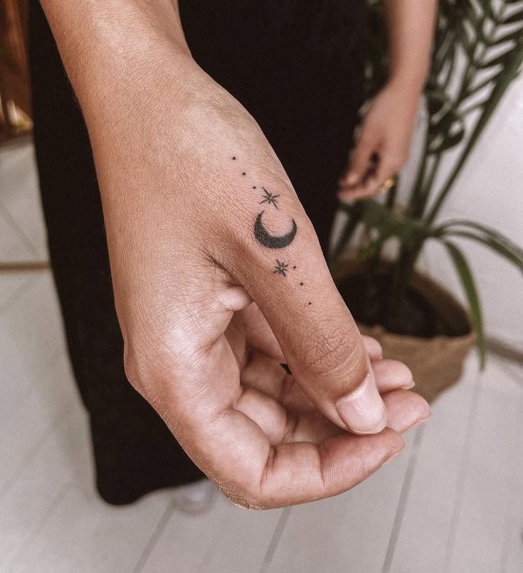 celestial minimalist finger tattoo design