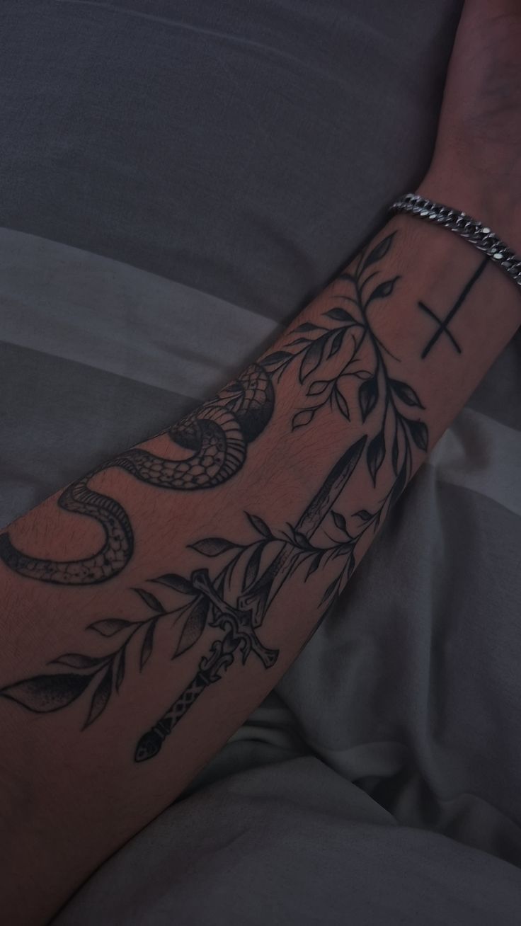Serpent and Sword: A Bold Forearm Tattoo Idea
