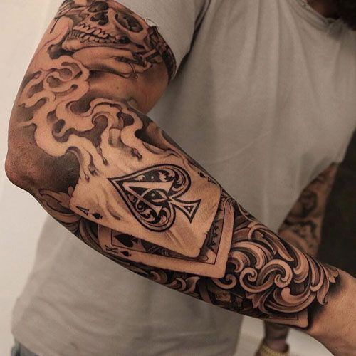 Bold Full Sleeve Tattoo with Skulls and Flames