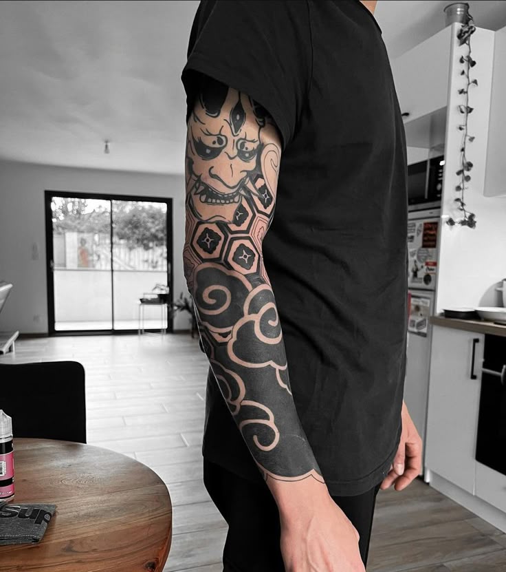 Bold Geometric Blackwork Sleeve Tattoo