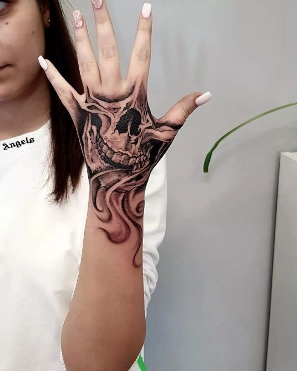 stunning realistic skull hand tattoo design