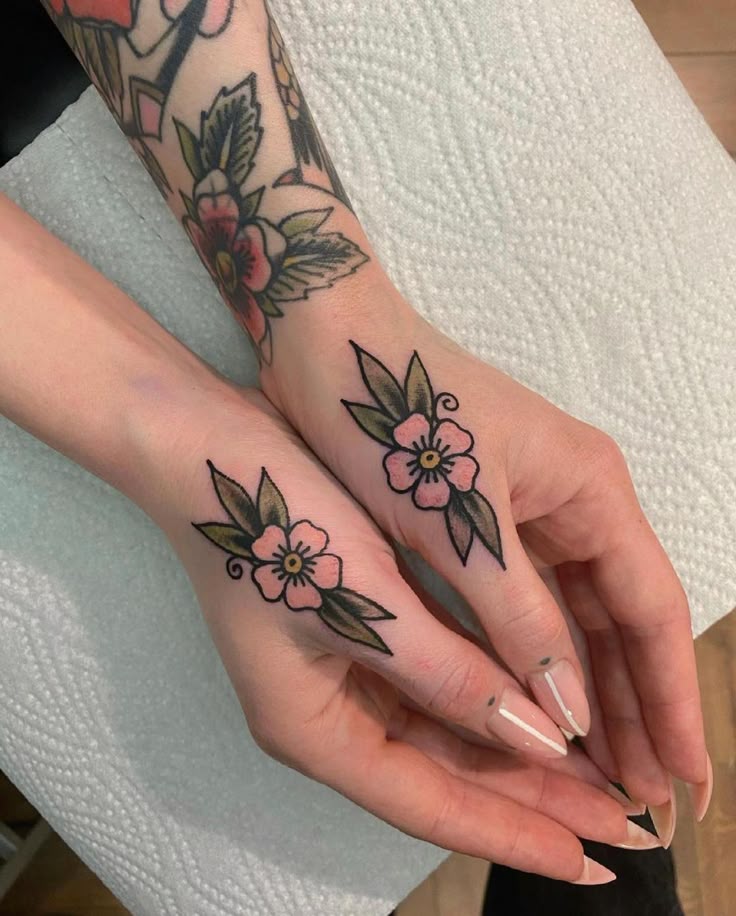 delicate flower hand tattoo design