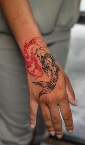 vibrant koi fish hand tattoo design
