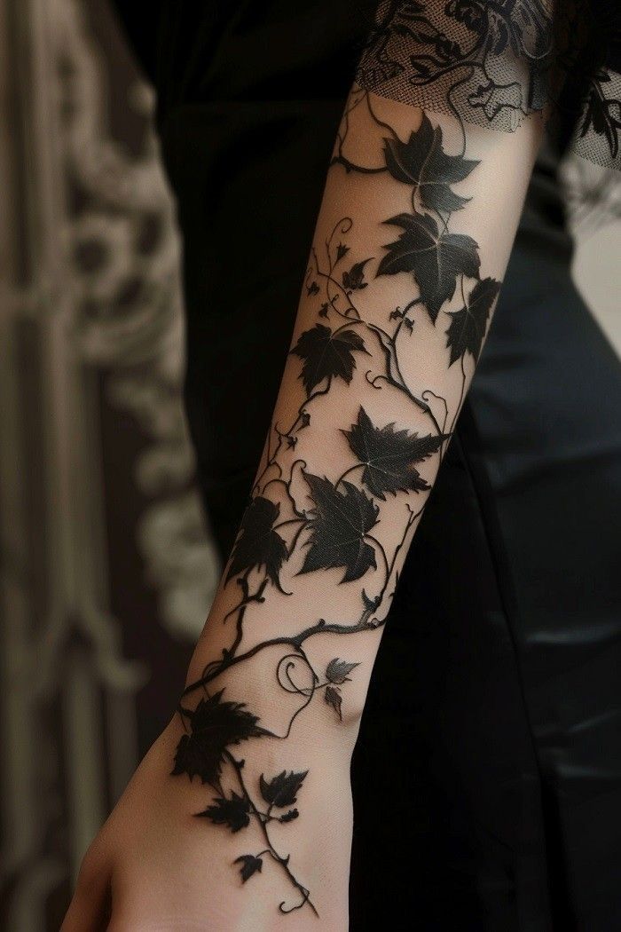 elegant blackwork vine hand tattoo