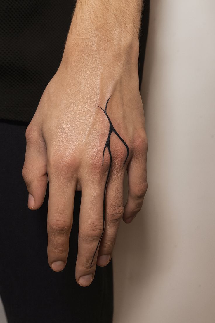 minimalist blackwork hand tattoo design