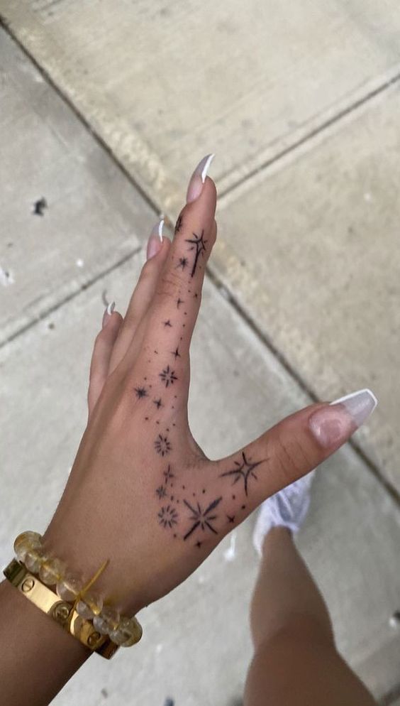 delicate star hand tattoo design