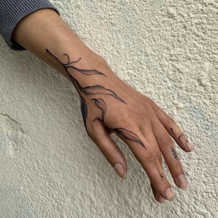 Elegant Blackwork Hand Tattoo Design