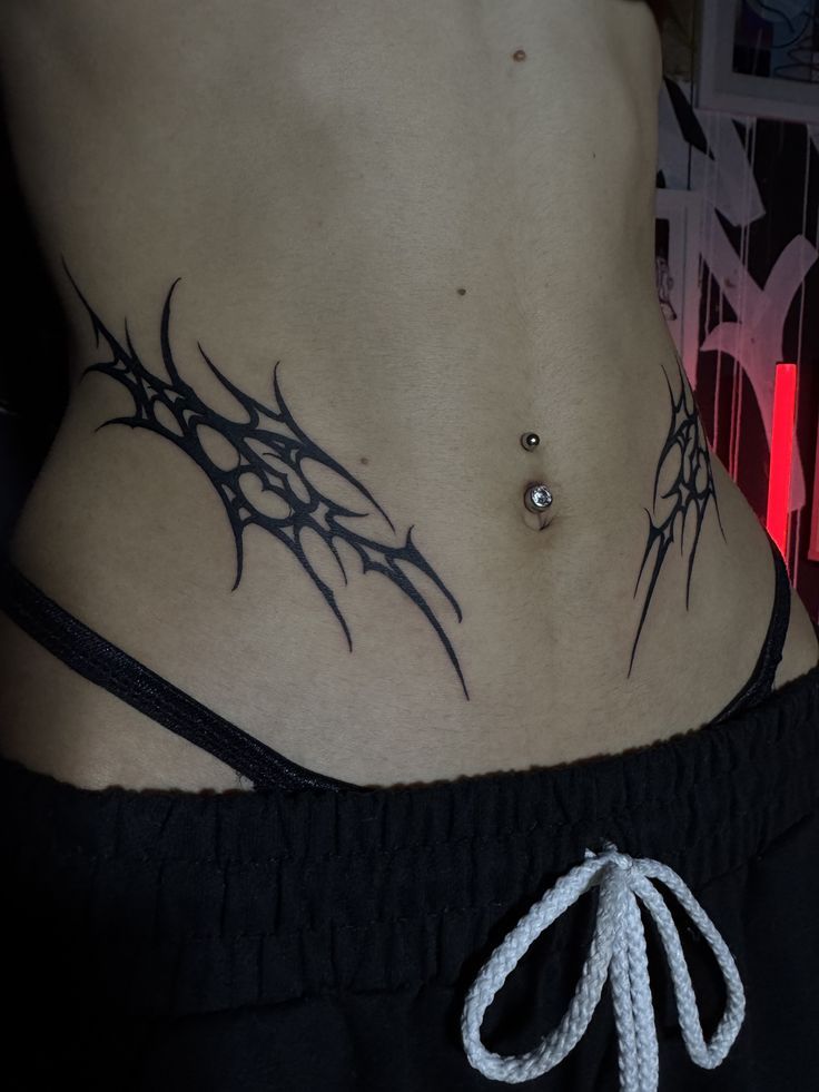 Bold Tribal Hip Tattoo Design