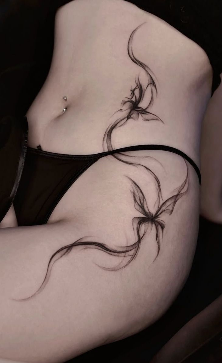 Elegant Blackwork Floral Hip Tattoo
