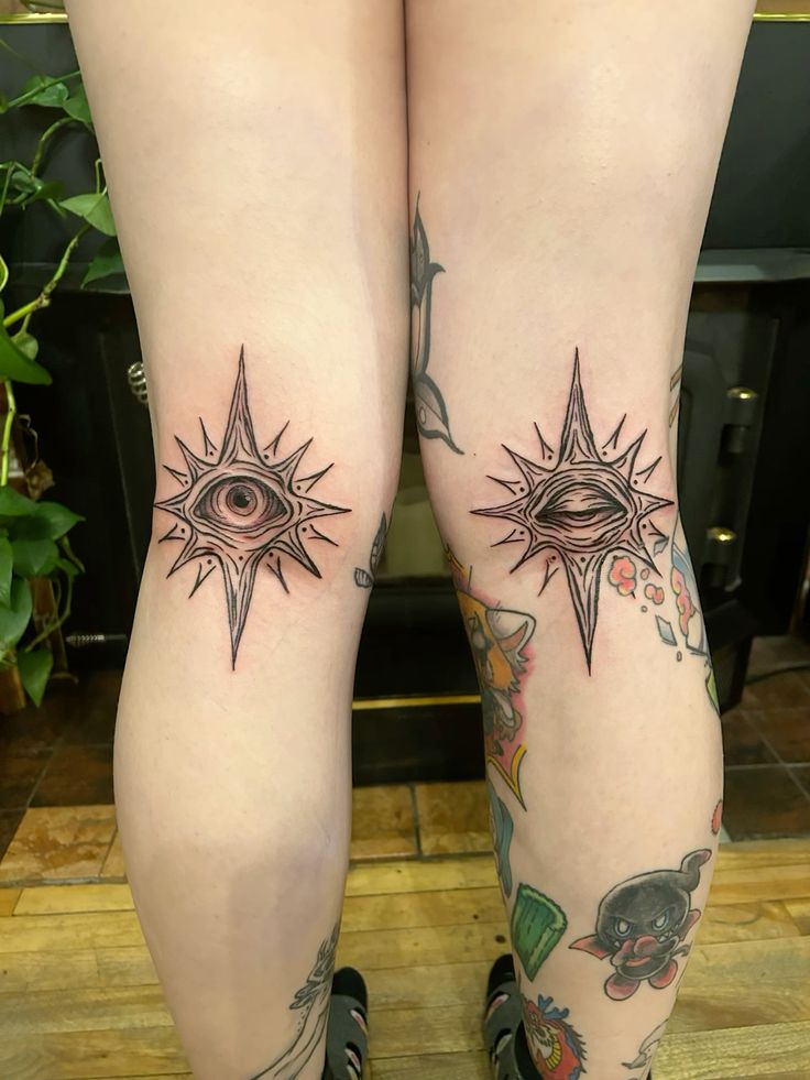 intricate blackwork knee tattoo with eye design