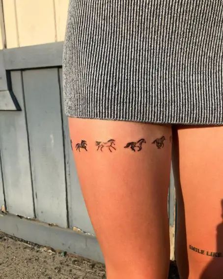 minimalist horse silhouette knee tattoo