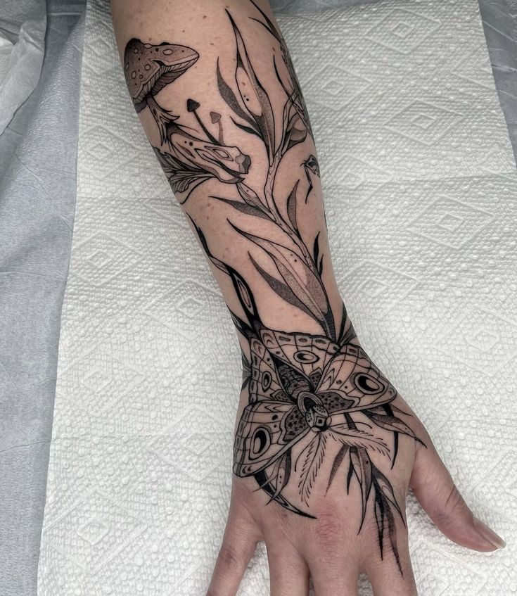 Elegant Blackwork Floral and Butterfly Arm Tattoo