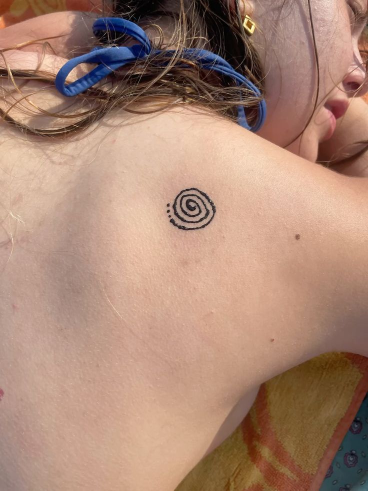 minimalist spiral shoulder tattoo
