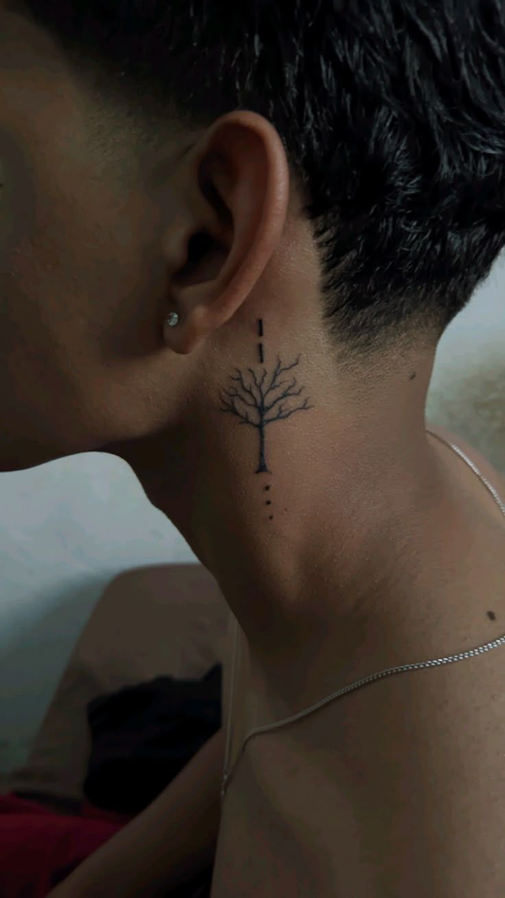 elegant minimalist tree neck tattoo