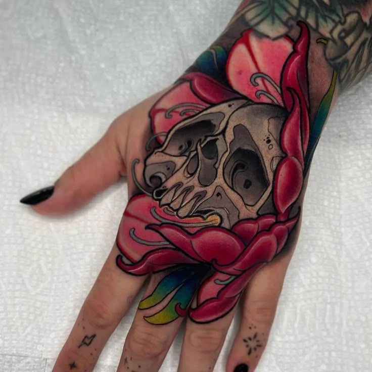Vibrant Skull and Flower Hand Tattoo Design