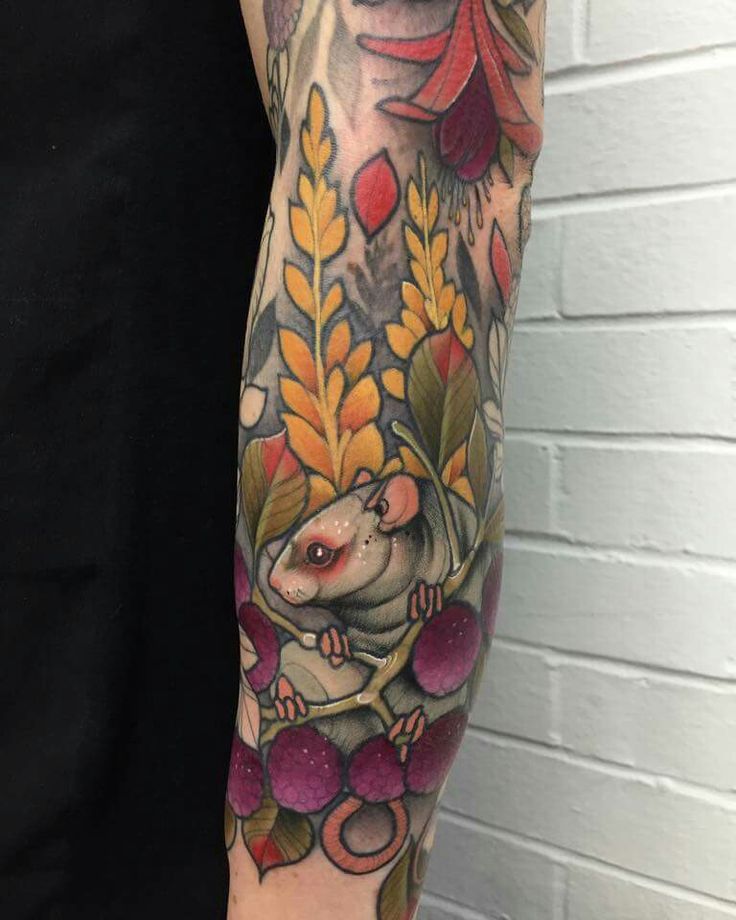 Charming Rodent in Vibrant Foliage Tattoo