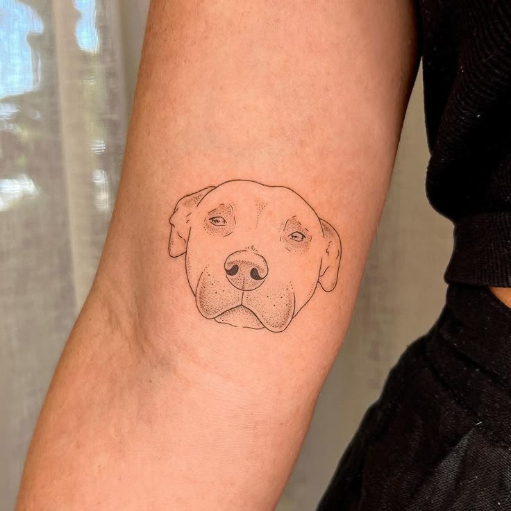 Minimalist Dog Portrait Tattoo Above the Elbow